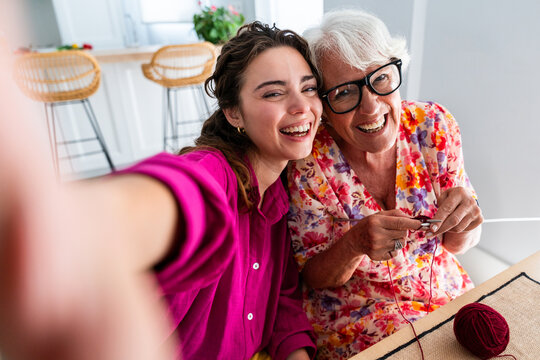 Beautiful grandmother and granddaughter together at home - Cheerful granma and nephew spending quality time together