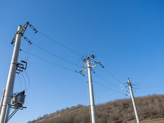 Utility Poles and Power Lines Against a Clear Blue Sky