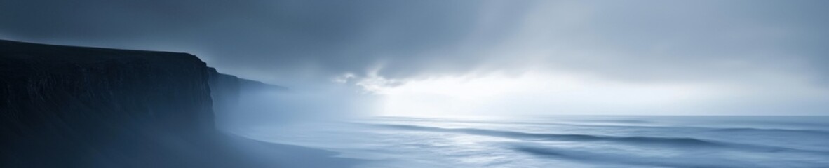 Landscape photograph of a cliff overlooking the ocean. the cliff is on the left side of the image, with the ocean on the right side.