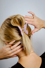 Fototapeta premium Butterfly-shaped hairpins in a girl's hair, behind