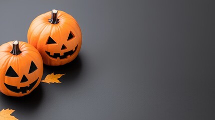 Two jack-o'-lanterns, autumn leaves, dark background; Halloween card