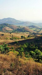Scenic View of Rolling Hills and Valleys Under Clear Blue Sky