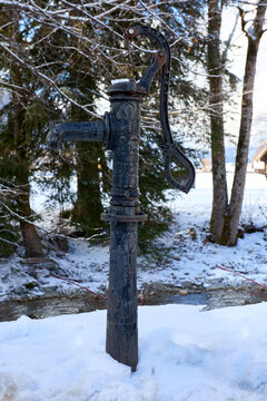 Vintage Water Pump in Snowy Landscape