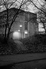 Cold concrete building with dead trees in the foreground. 