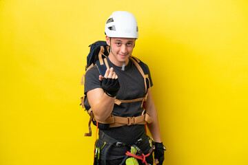 Fototapeta premium Young rock climber Brazilian man inviting to come with hand. Happy that you came