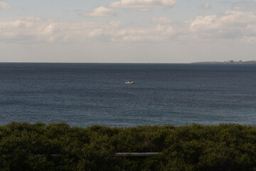 Obraz premium Lonely Fishing Boat Floating on the Open Sea, Miyakojima, Japan