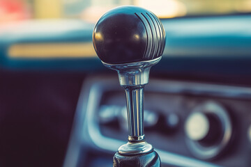 A worn-out classic car gear shift lever, showcasing vintage charm and mechanical details, with copy space. Warm rustic lighting. Retro automobile background 