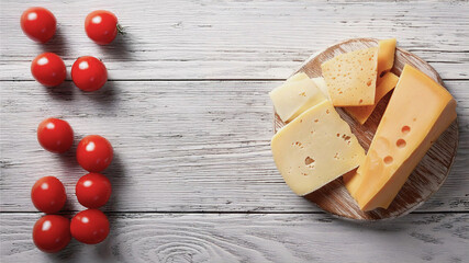 Delicious Cheese Selection on Rustic Wooden Table with Copyspace