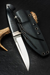 Hunter hand made knife. Handle - titan and carbon. Copy space.
