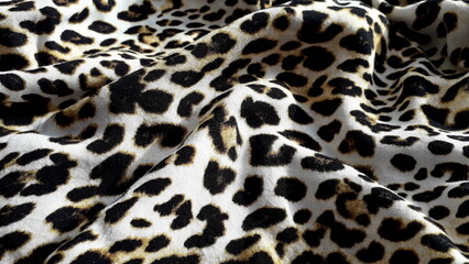 Leopard print. Lightweight natural fabric for summer clothing with an animal print. Viscose. Cotton. Cotton fabric texture. Textile background.