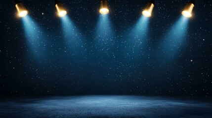 Five golden spotlights shine down from above onto a dark blue, starry night sky, illuminating a textured, empty stage below.
