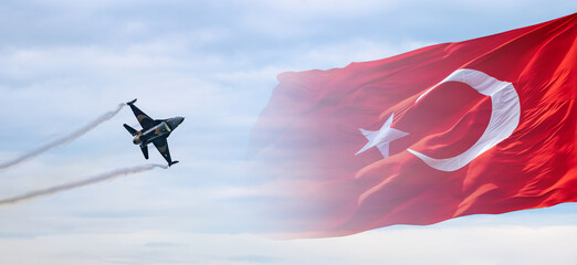 Turkish Soloturk F-16 fighter jet flying against backdrop of Turkish flag. Soloturk F-16 fighter jet performing an airshow, with flag waving in background. Air force aerobatics. Banner, wallpaper