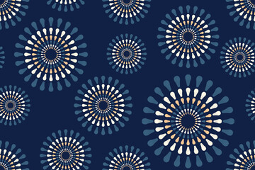 Seamless pattern with blue and beige circles fireworks on a dark blue background. Motifs Ikat floral paisley embroidery floral.ikat ethnic oriental pattern traditional. Design for texture, fabric