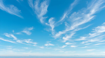Obraz premium Clear blue sky with wispy clouds, landscape background, perfect for travel or nature designs