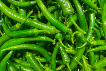 Green peppers on the grocery store counter.