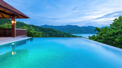 Fototapeta premium Serene Infinity Pool Overlooking Lush Green Mountains at Dusk
