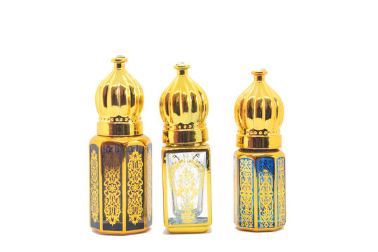 Antique glass bottle filled with indian fragrance oil (Attar). white background, Expensive oil agarwood tree. Arabian oud attar perfume or agarwood oil fragrances in mini bottle.Arabic perfume known