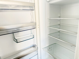 Empty Refrigerator Shelves. High quality photoA clean and spacious refrigerator with empty glass shelves and transparent door compartments, ready to be stocked with fresh groceries. The minimalist and