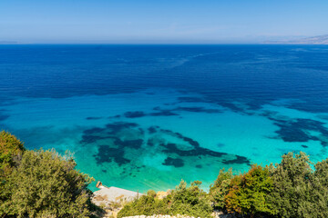 Albania, Vlorë County, Ksamil, Shpella e Pëllumbave - 17 August 2024 - The intense colors of the Albanian sea of ​​Ksamil from above