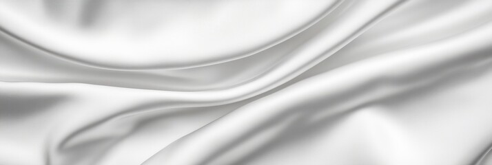 Fototapeta premium Elegant white silk fabric with smooth flowing folds and soft texture background