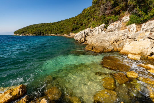 Albania, Vlorë County, Ksamil - 17 August 2024 - Glimpse of turquoise sea and rocks in Ksamil
