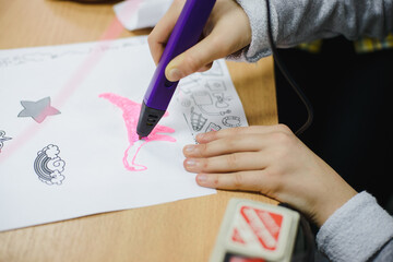 The child is in the process of learning, engaged in science. The girl draws, designs