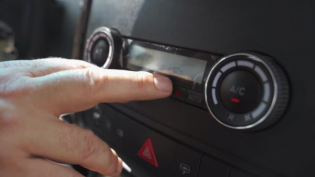 In a spacious minibus, a driver expertly manages the heating and air conditioning system, ensuring passengers enjoy a pleasant and comfortable journey. The focus is on maintaining an ideal atmosphere.