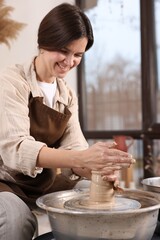 Hobby and craft. Smiling woman making pottery indoors