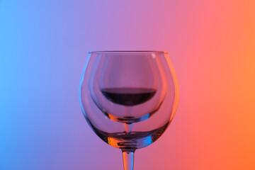 Wine glasses on color background, closeup view
