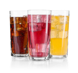Soda water of different flavors with ice cubes in glasses isolated on white