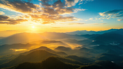 Obraz premium Aerial view of mountains and hills during golden sunset with blue skies and clouds from an airplane window 