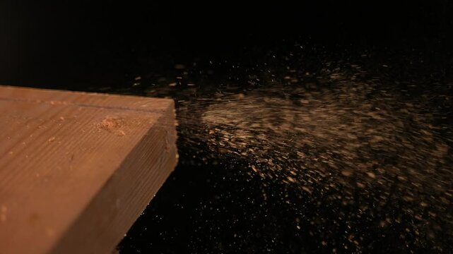 Wood Chips Falling against Black Background, Slow Motion 4K