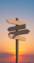 Crossroads at Sunset: Wooden Direction Signs Pointing the Way Forward. Choices, Decisions, and New Beginnings Await!