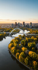 Fototapeta premium Edmonton's Autumn Glory: A Stunning Aerial View of the Walterdale Bridge & City Skyline at Sunset, Embracing Nature & Architecture.