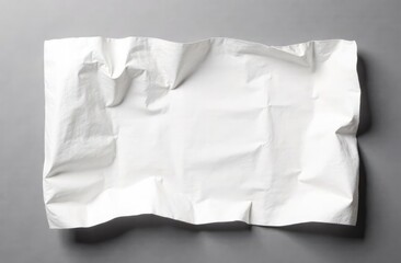 Obraz premium Crumpled piece of white parchment or baking paper on grey background. Top view. Copy space for text and design element