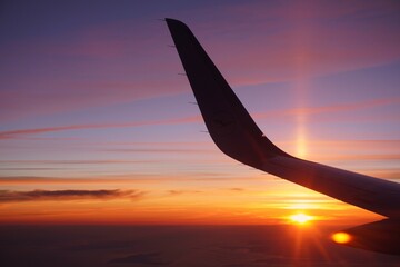 airplane flying over the sunset