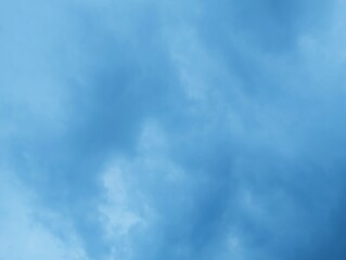 Dramatic sky with dense clouds in varying shades of blue and overcast