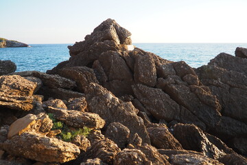 Waves gently crash against the rugged rocks while the sun sets over the horizon. Experience the serene beauty of this coastal location filled with natural wonders. Canj, Montenegro, Adriatic sea