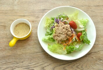 mashed tuna with vegetable salad dressing Japanese roasted sesame cream sauce on plate