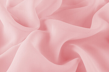 Obraz premium Silk fabric texture, pink soft waves. An elegant festive backdrop. Pink chiffon fabric drapery. Holiday design layout. tissue sample.