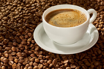 A beautifully prepared cup of freshly brewed coffee sits elegantly atop a bed of coffee beans