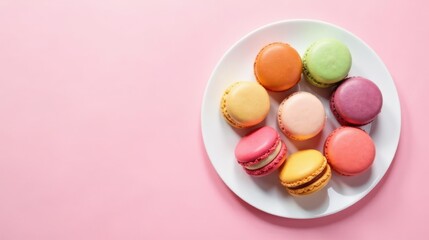 Obraz premium A Delightful Arrangement of Colorful Macarons on a Plate Against a Pastel Pink Background