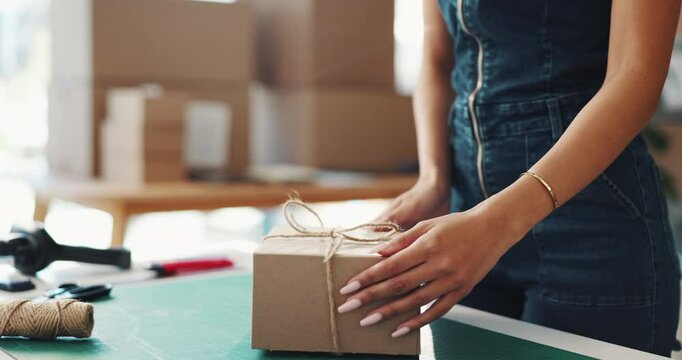 Woman, bow or hands with box for delivery, supply chain or packaging order at warehouse. Small business, strings tie or owner wrapping parcel, gift or product for shipping, present or courier service
