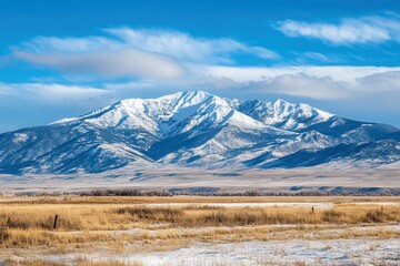 Snowy Mountain Range Under a Blue Sky .