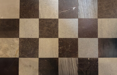 Vintage Checkered Marble Floor Pattern with Alternating Black and White Textured Tiles in Classic...