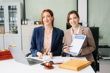 Obraz premium Professional female lawyers consulting on legal cases in a modern office. Perfect for law, business, justice