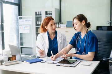 Doctors and nurses collaborating in a modern medical office, showcasing teamwork and patient care.