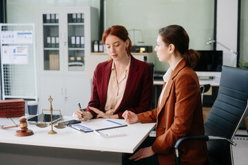 Obraz premium Professional female lawyers consulting on legal cases in a modern office. Perfect for law, business, justice