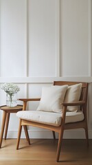 60. A wooden lounge chair, side table, and soft pillows, in a room with white walls