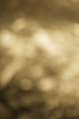 Abstract blurred sepia-toned background with bokeh lights and soft focus